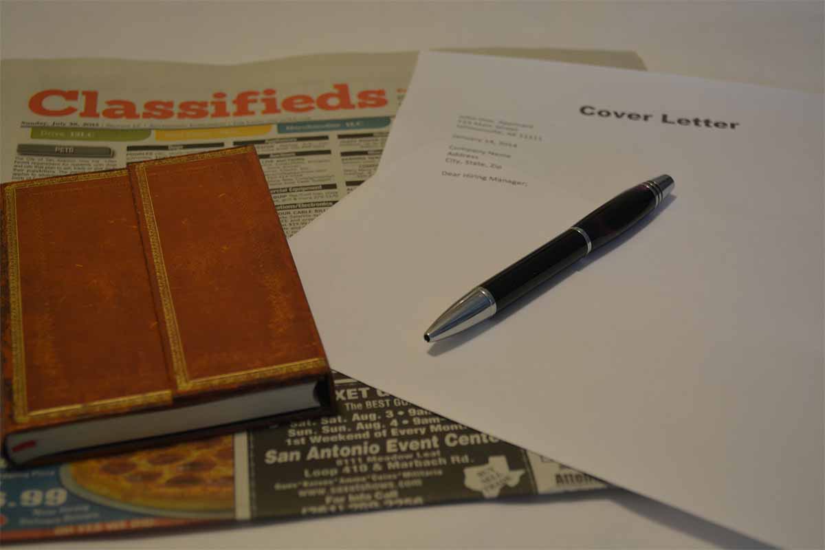 Illustration of a resume with a magnifying glass over it.