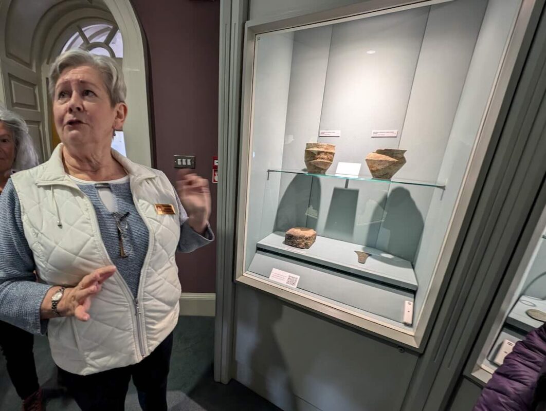 Docent Jackie Shannon shows off a collection of pottery at the Hunt Museum in Limerick, Ireland.