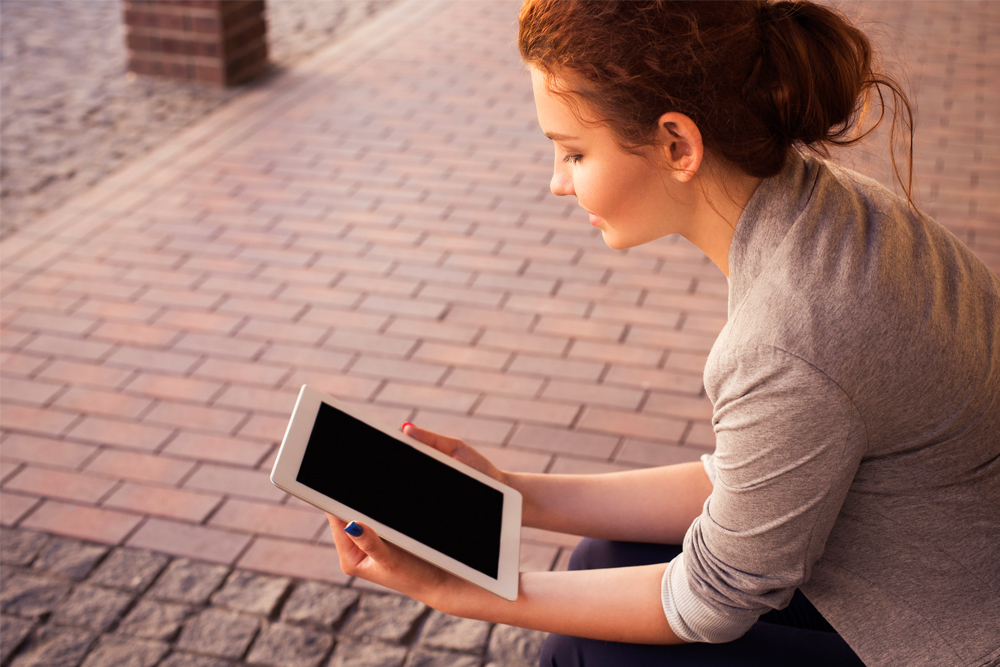 A person using a tablet device while relaxing