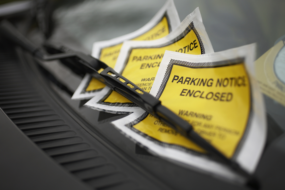 A parking ticket on a car windshield